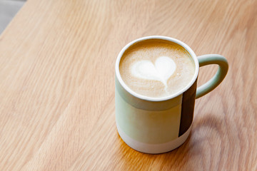 Hot coffee art latte on wooden table