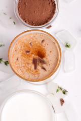 Lassi chocolate traditional indian cold drink next to cocoa yogurt close-up