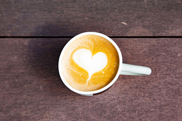 Hot coffee art latte on wooden table