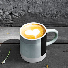 Hot coffee art latte on wooden table