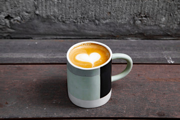 Hot coffee art latte on wooden table