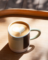 Hot coffee art latte on wooden table