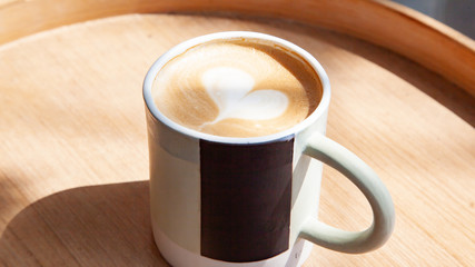Hot coffee art latte on wooden table