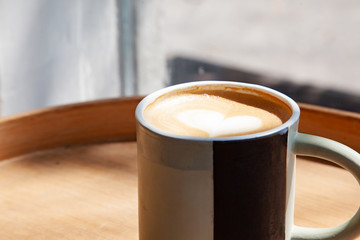 Hot coffee art latte on wooden table