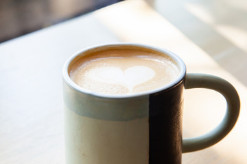 Hot coffee art latte on wooden table