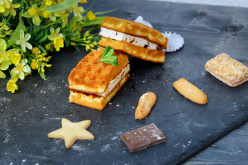 Near the spread of snow little meringue On graphite colors of flat stone meringue tiles there are shaped cookies