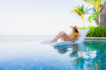 Portrait beautiful young asian women happy smile relax around outdoor swimming pool