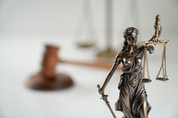 Law symbol composition. Gavel of the judge, Themis statue and scale of justice on off-white background.