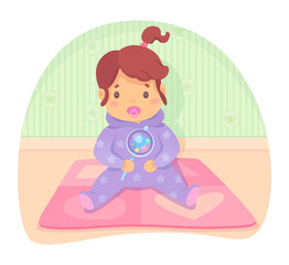 Baby girl in jumpsuit with dummy holding beanbag