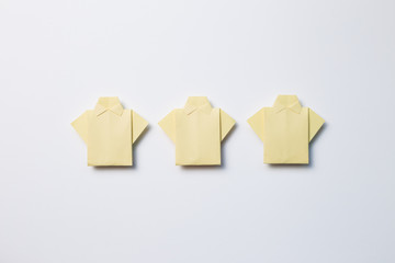 Yellow paper shirt origami on white background