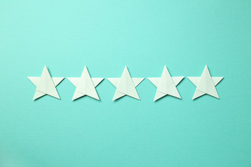 Five stars quality rating on mint green background