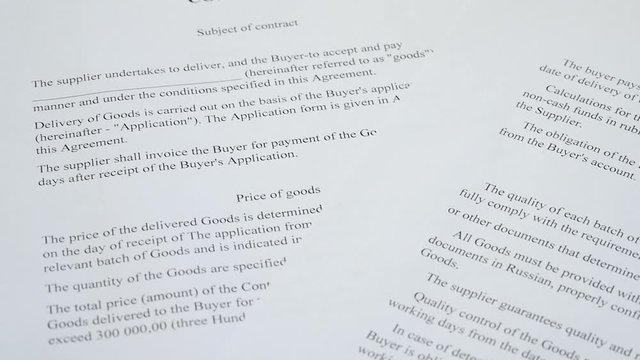 Abstract the text of the contract on paper closeup. The pen is on the paper with the contract. Business, responsibilities, partnership.