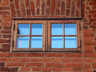 Red brick old wall and two windows in it