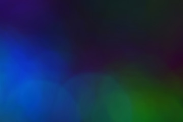 Multicolor bright large bokeh on a dark background. Macro. Copyspace.