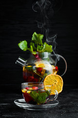 Forest berry and fruit tea. Hot winter drinks. On a black background. Top view.