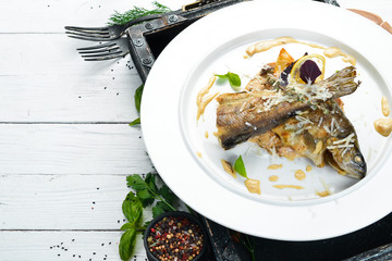 Baked trout on a plate. Dishes, food. Top view. Free space for your text.