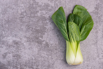 Pak Choi on a grey structured background