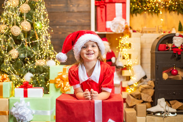 Obraz na płótnie Canvas Cute little kids celebrating Christmas. Christmas Celebration holiday. Happy cute child in Santa hat with present have a Christmas. Little Santa Claus gifting gift.