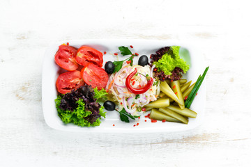 Assorted pickled vegetables on a plate. Ukrainian cuisine. Restaurant dishes. Top view. Free space for your text.