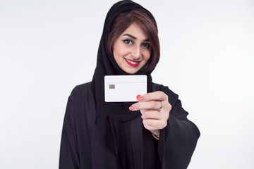 Arab Female holding credit card, focus on the debit card, over white background