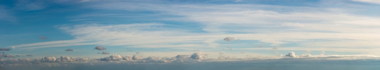 Fantastic clouds against blue sky, panorama