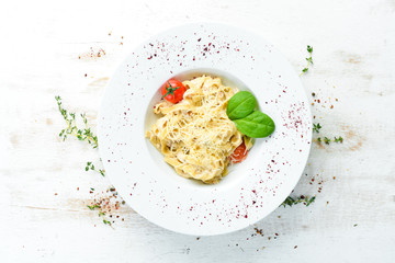 Italian traditional pasta with parmesan cheese and tomatoes. Top view. Free copy space.