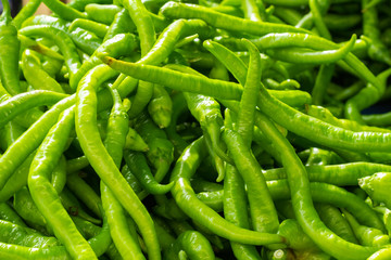 Pile of green hot chilli pepper.