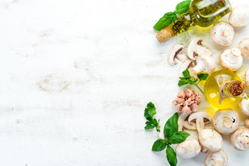Champignons with spices on the old kitchen table. Top view. Free space for text.