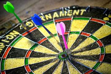 Dart board with dart arrows.  Dart board in black and yellow colors.