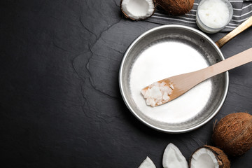 Flat lay composition with coconut oil and frying pan on black table, space for text. Healthy cooking