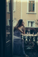 Cheerful girl drinking coffee in morning. Beautiful young woman enjoying the freshness of the morning on the balcony. Copy space. Sexy girl. Woman with tea. Holiday and vacation.