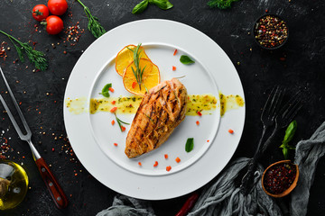 Baked chicken fillet with sauce on a plate. Dishes, food. Top view. Free space for your text.