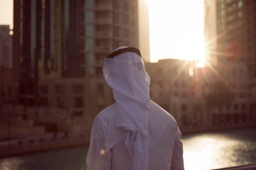 Middle Eastern Emirati man standing alone in Dubai Down town looking forward