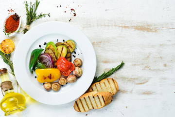 Grilled vegetables: zucchini, tomatoes, paprika, onion. Top view. Free space for your text.