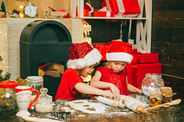 Merry Christmas. Christmas food and drink. Santa kids making cookie. Funny kids are preparing the...