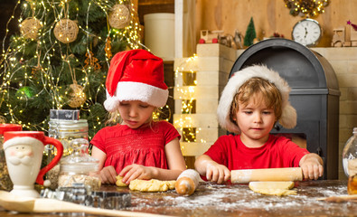 Merry Christmas. Funny children chefs in santa hats prepare holiday food. Thanksgiving day and Christmas for children.