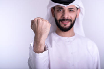 Exited Arab man showing Yes sign with hand - success concept