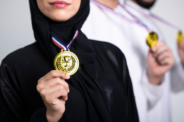 Arab woman showing g her medal - success an winner concept