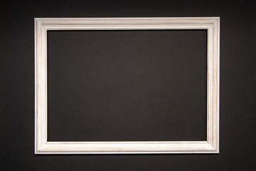 White photo frame on a black background. Space for text, copy space.