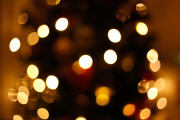 Obraz premium Lights of the christmas tree in the city in blur. Bokeh background concept. New year lights defocused. 