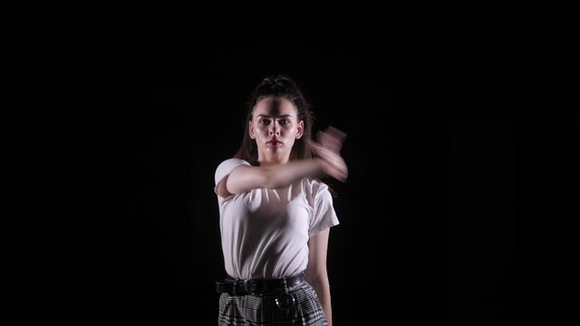 young beautiful girl dancing vogue in the studio on a black background, isolated