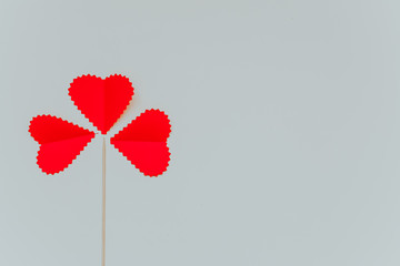 Three red hears with a stick on the light grey background. Saint Valentine s Day concept. 