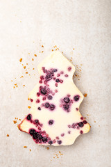 Winter Christmas Cheesecake with cranberry jam on top. Cake in the form of Xmas tree. Holiday festive dinner or dessert concept. Light grey background, top view, copy space