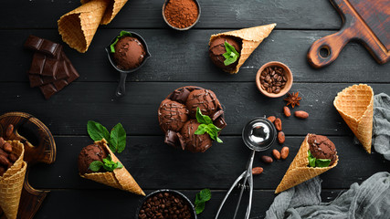 Ice cream with chocolate. Making ice cream on Wooden background. Top view. Free space for your text.