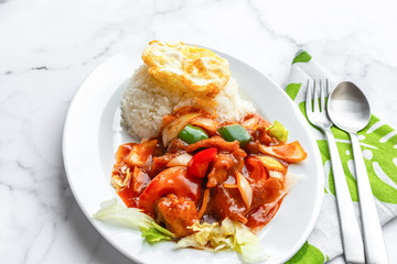 Sweet and Sour Chicken or Fish, fried egg and jasmine Thai rice. Asian food on table concept.
