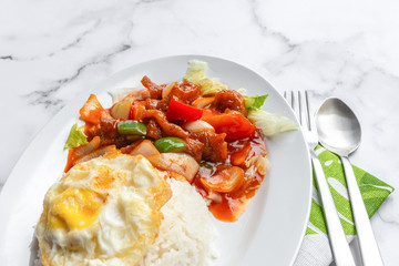 Sweet and Sour Chicken or Fish, fried egg and jasmine Thai rice. Asian food on table concept.