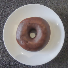Chocolate donut on white plate