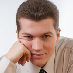 young male entrepreneur looking studyingly at camera camera.