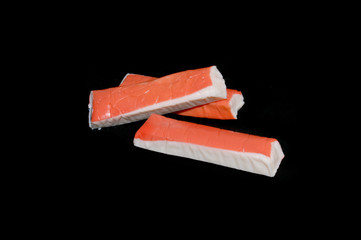 crab sticks isolated on black background