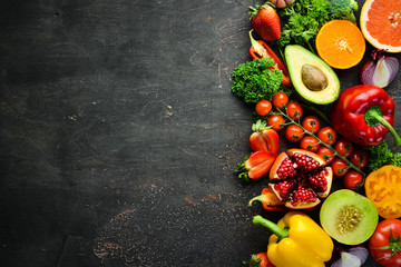 Fresh fruits, vegetables and berries. On a black background. Banner Top view. Free space for your...